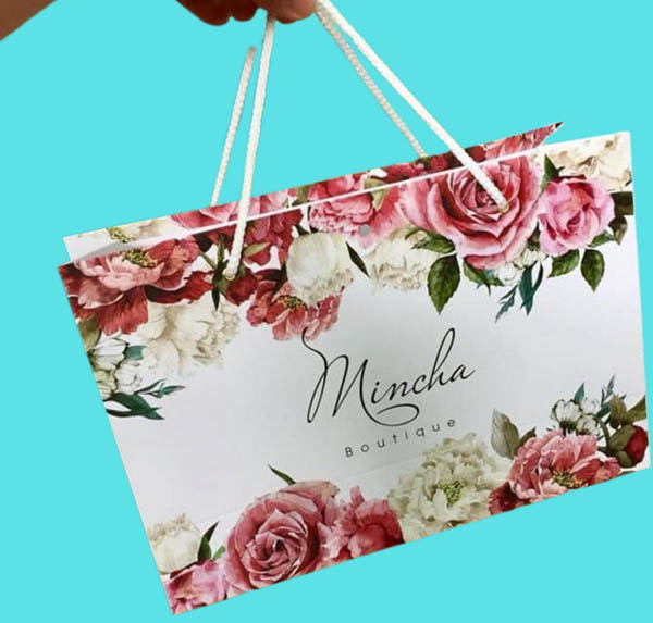 Túi giấy shop quần áo với thiết kế viền hoa hồng cùng tên thương hiệu